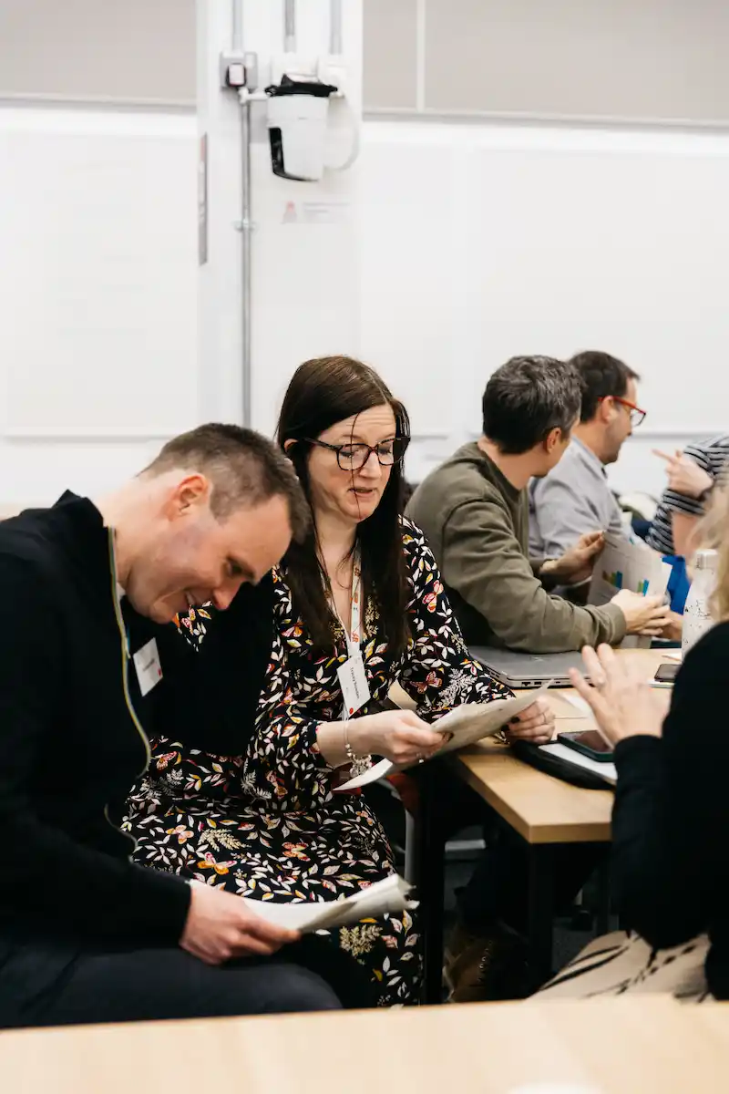 People in a meeting looking at papers