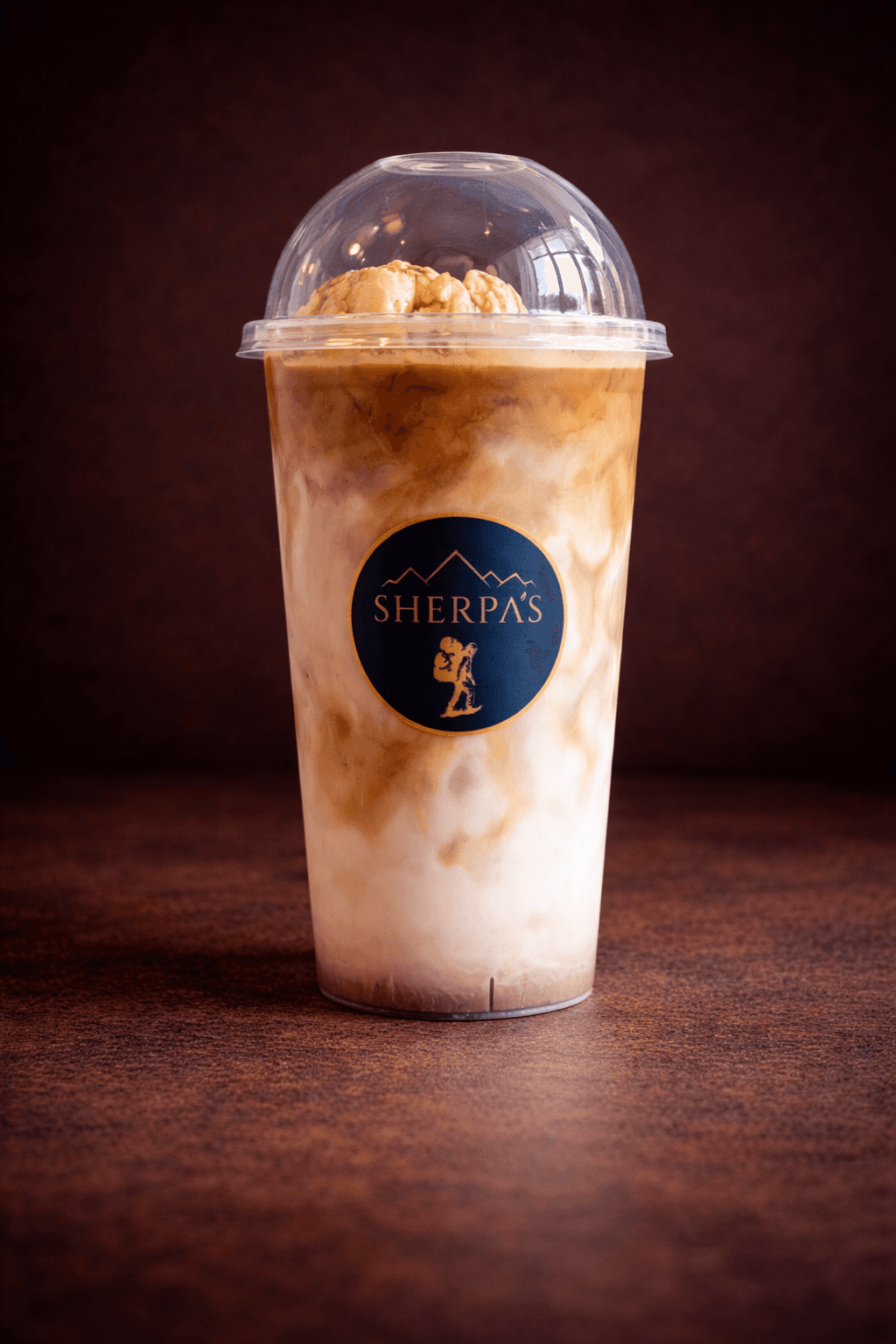 Ice Cream Latte with a scoop of vanilla ice cream and espresso in a Café Sherpa's branded cup, Brookfield WI. Coffee meets dessert in every sip.