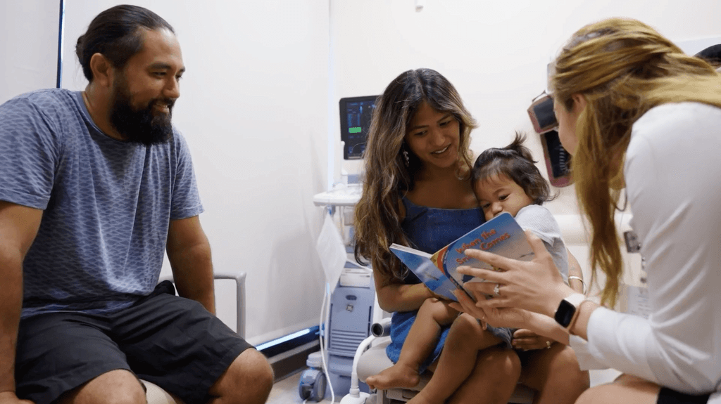 Doctor reviewing information with family and child