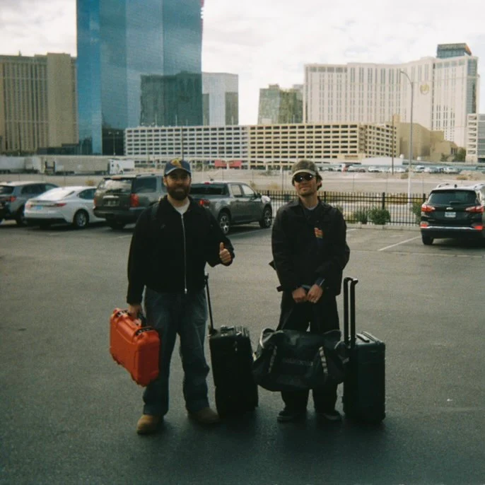 A thoughtful young person with dark hair gazes to the side, captured in soft black and white lighting.