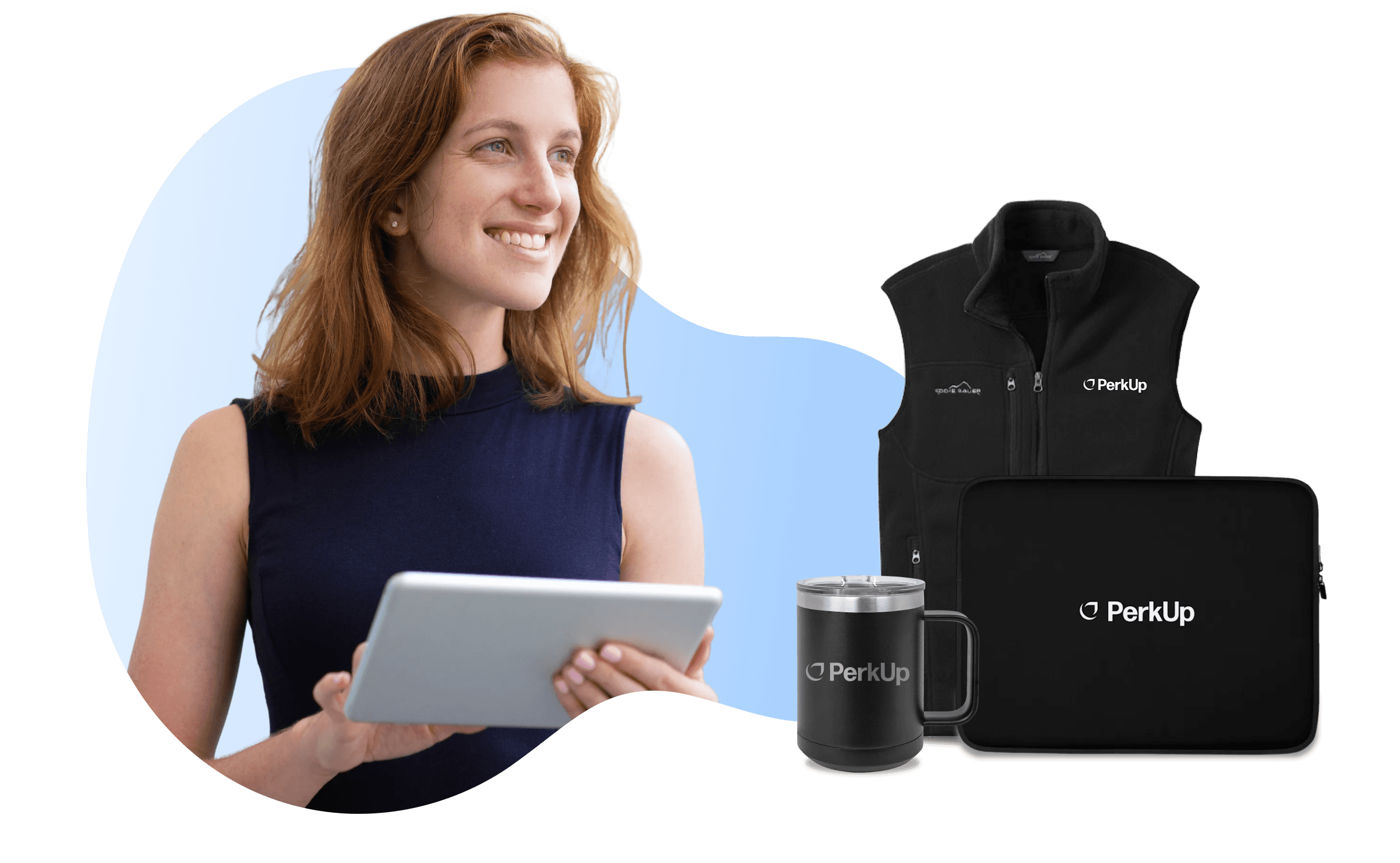 A smiling woman touching a tablet, with a mug, vest, and laptop sleeve on her side.