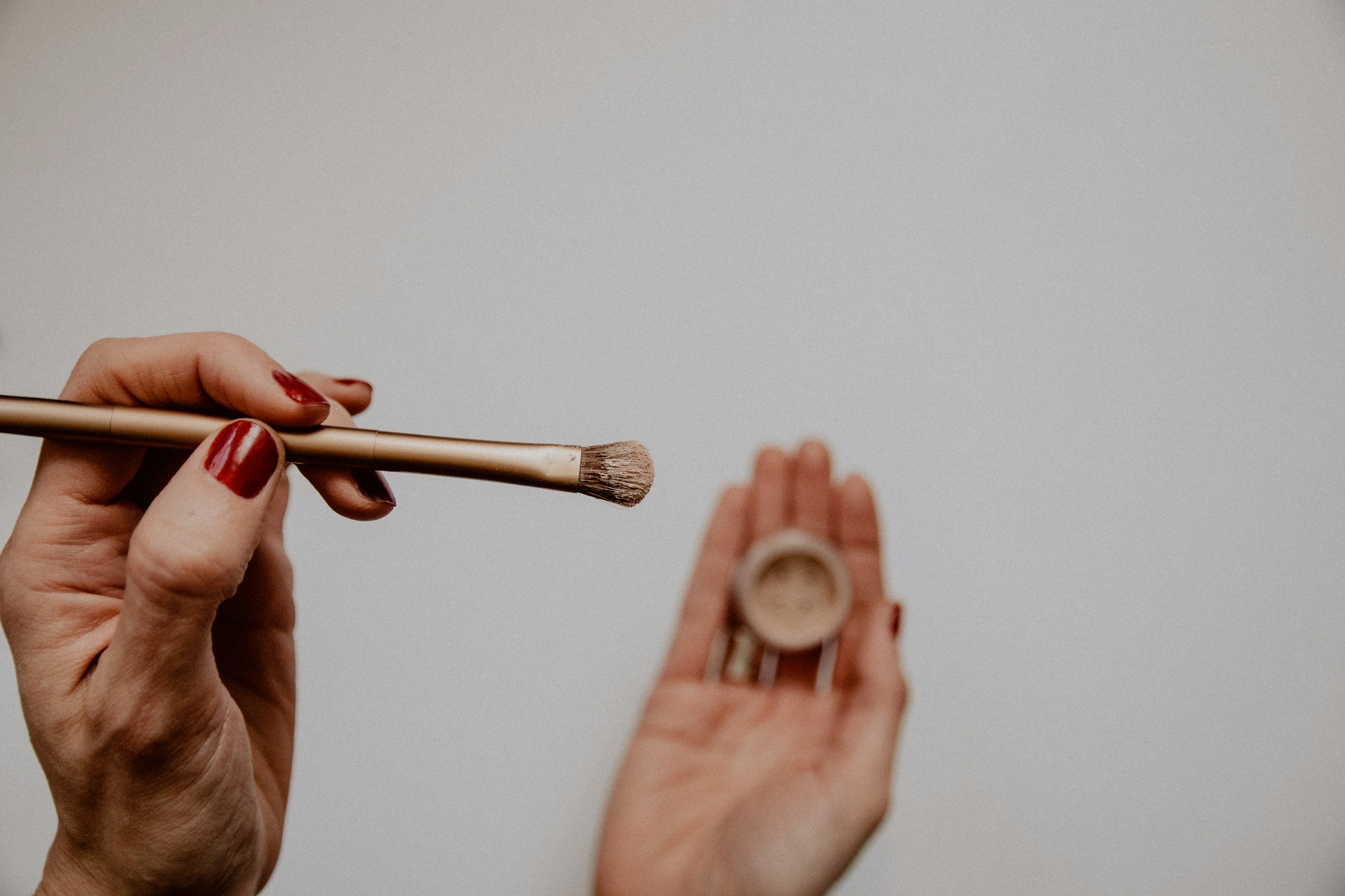 Person holding Eyeshadow Brush - How to Choose Eyeshadow Color According to Dress