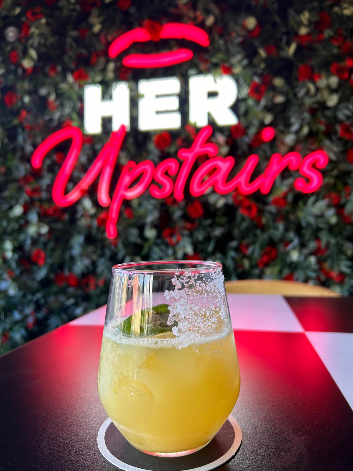 No Regrets Spicy Margarita  0.0%  cocktail beside neon sign