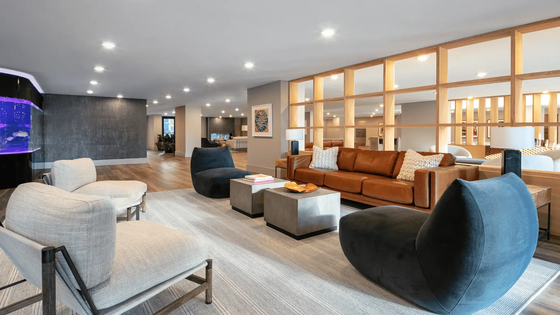 Modern living room featuring stylish furniture, wooden accents, and soft lighting, creating a cozy atmosphere.