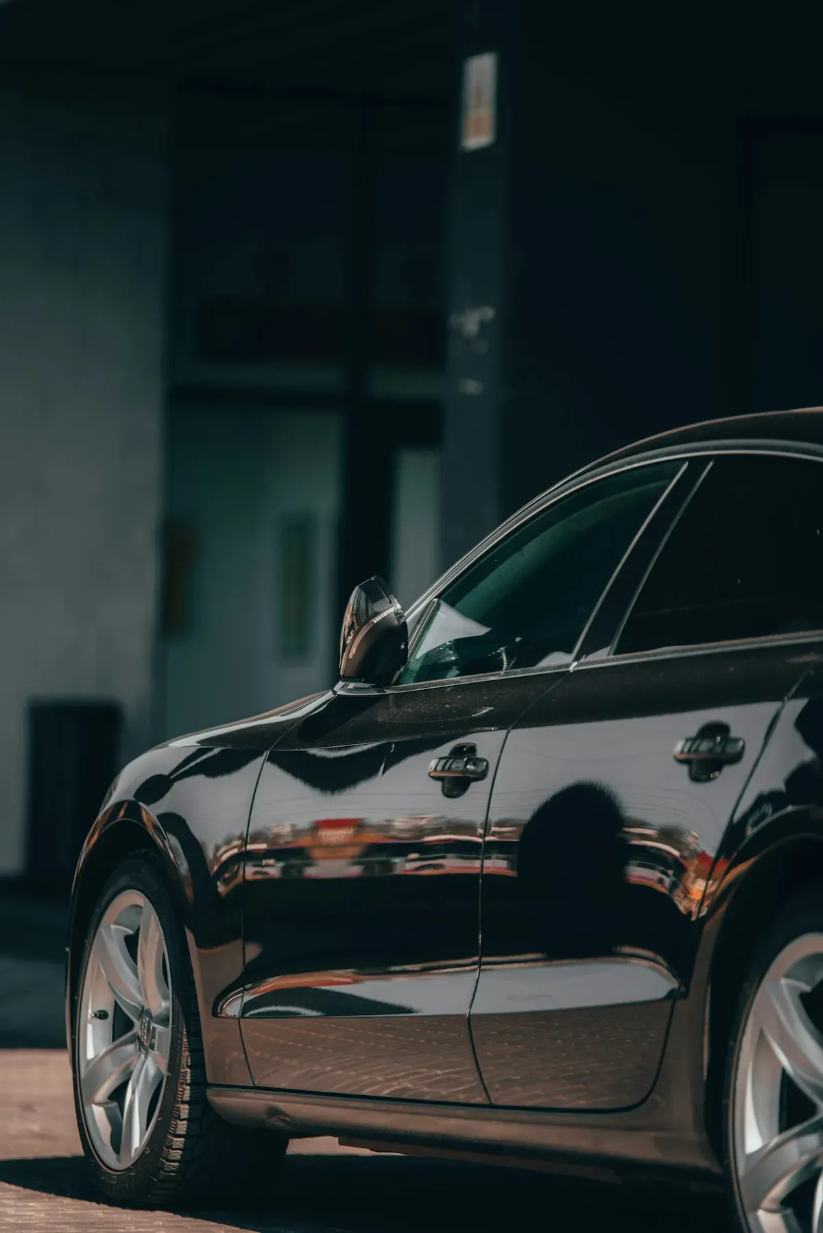 side view of a car with glossy black paint