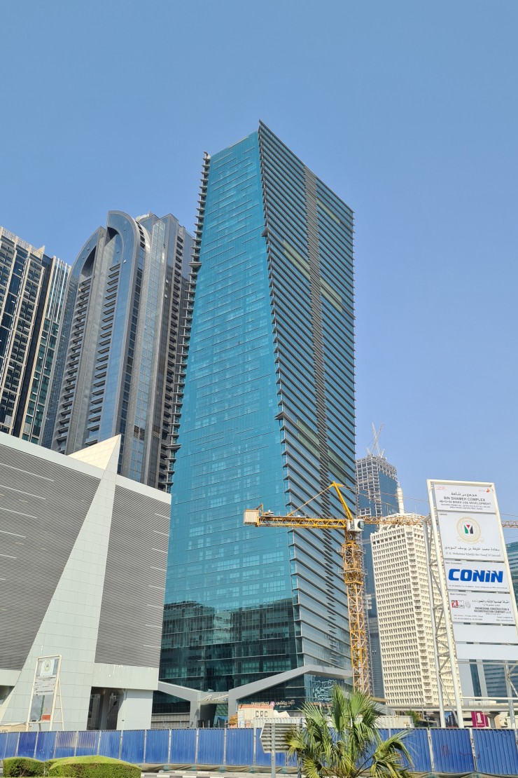 Modern glass architecture of Sama Tower, a prime focus for our dedicated real estate agent services.