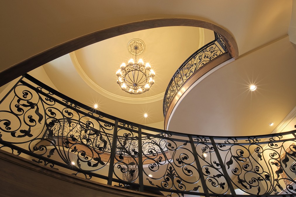 Curved institutional staircase with iron balustrade symbolising structured family investment company governance and long-term capital planning.