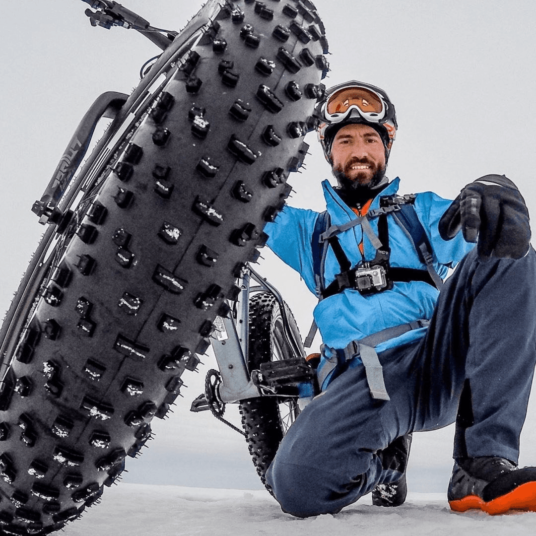 man in black suit jacket holding white ceramic mug