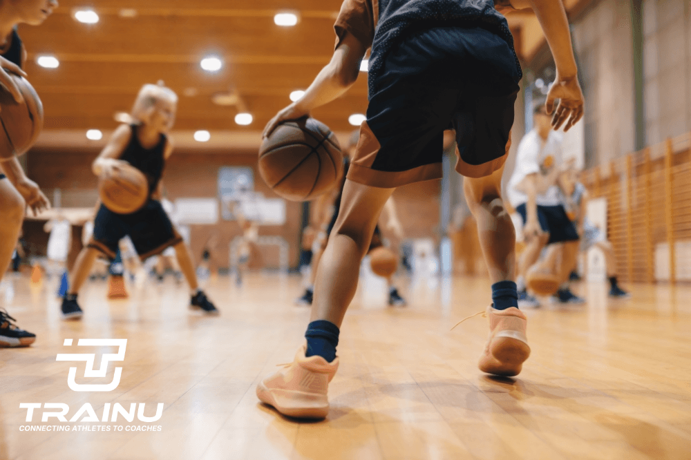 Group of young athletes training on a field with a coach giving instructions.