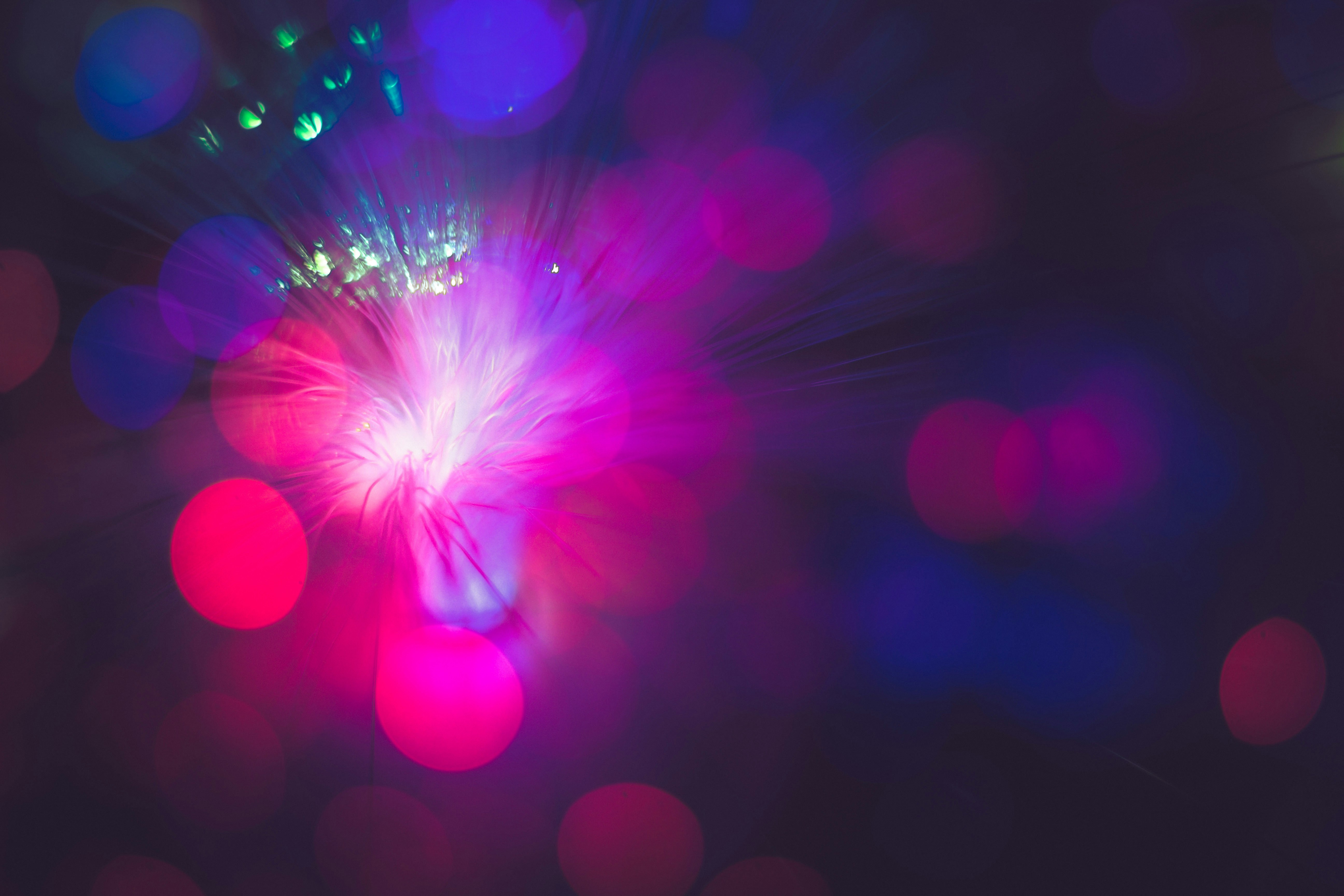 Background featuring blurred red and purple circles, representing light.