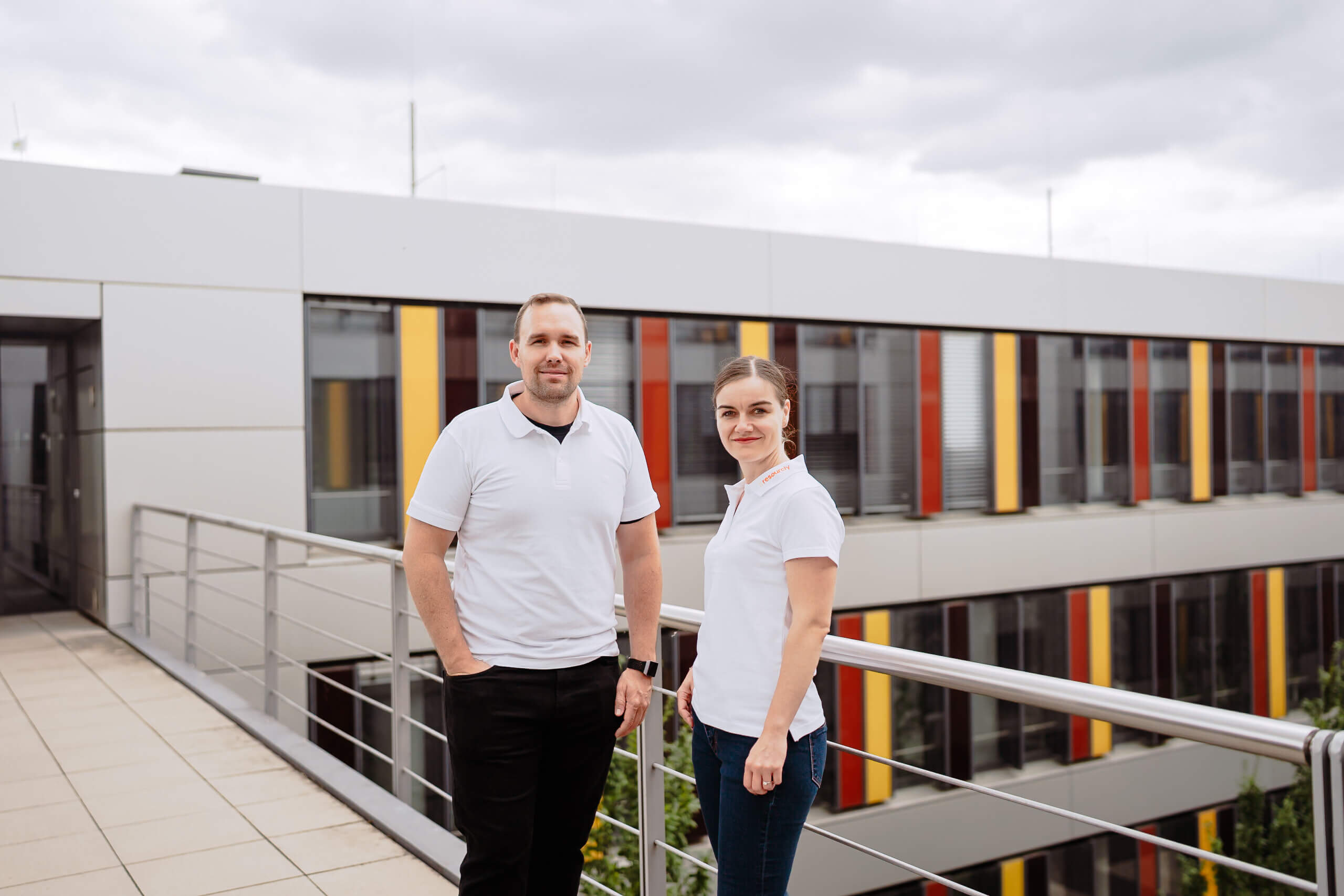 woman in blue tank top standing beside white wall