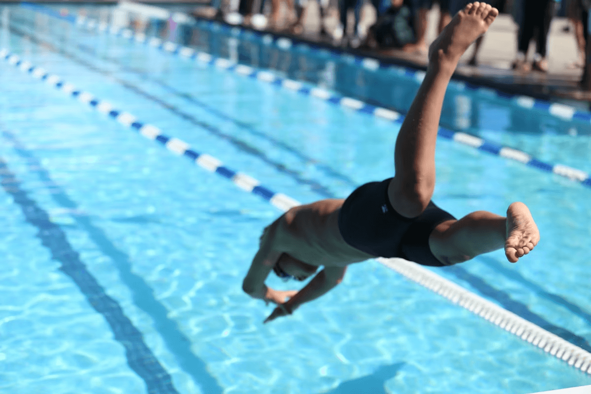 person jumping into a pool