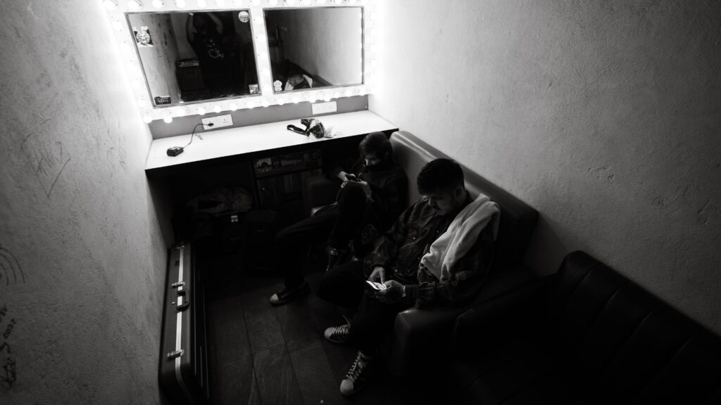 Man sitting on a Sofa in dressing room.