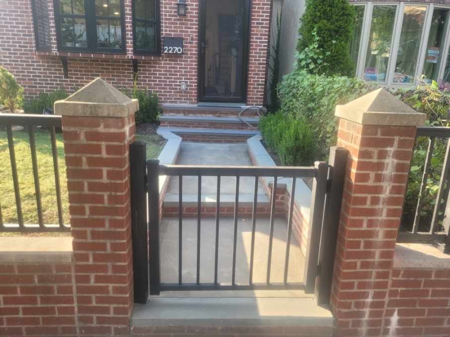 front yard black gate with brick collums