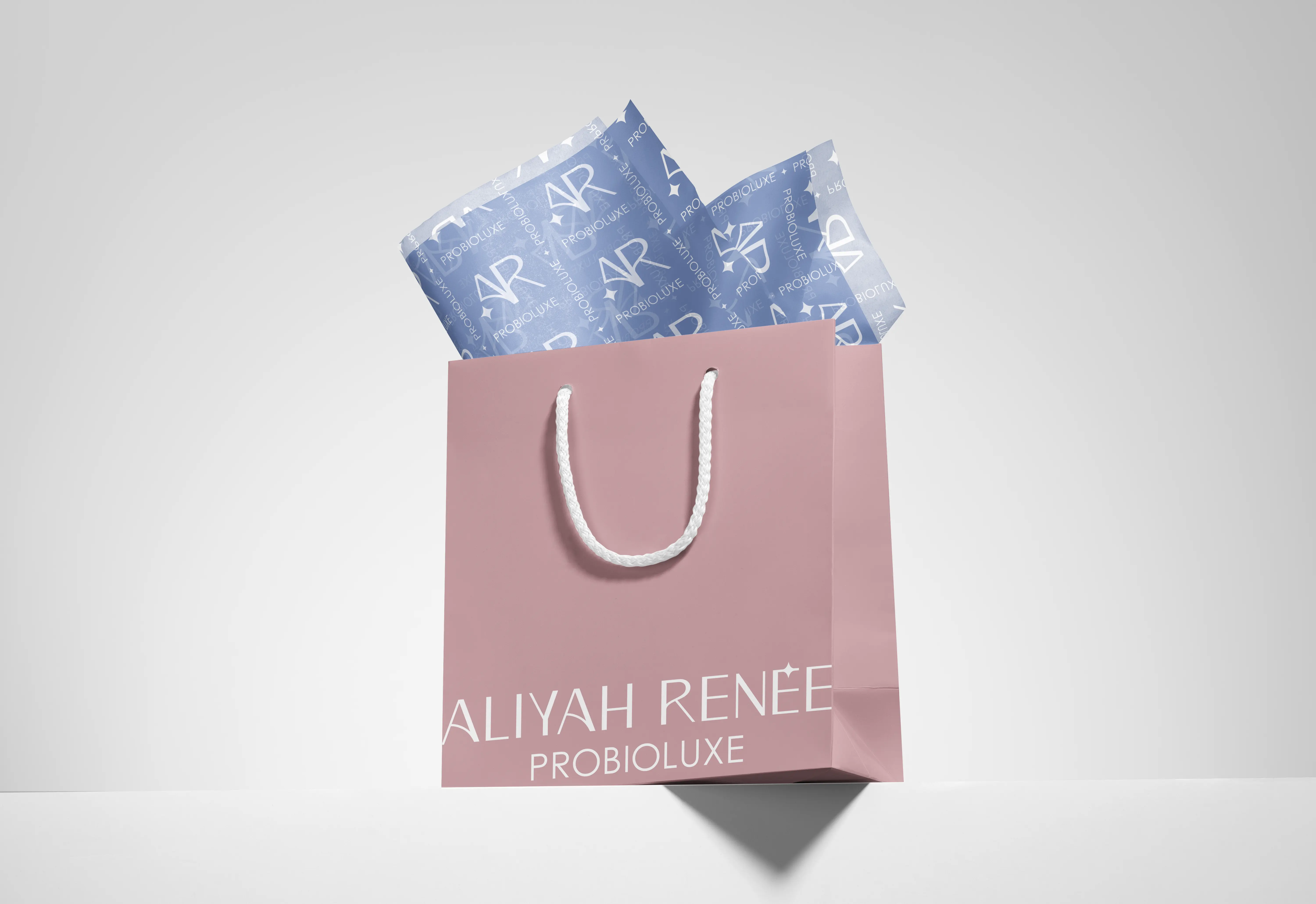 Premium skincare packaging design for ARP Probioluxe – branded shopping bag and tissue paper showcasing cohesive brand identity system