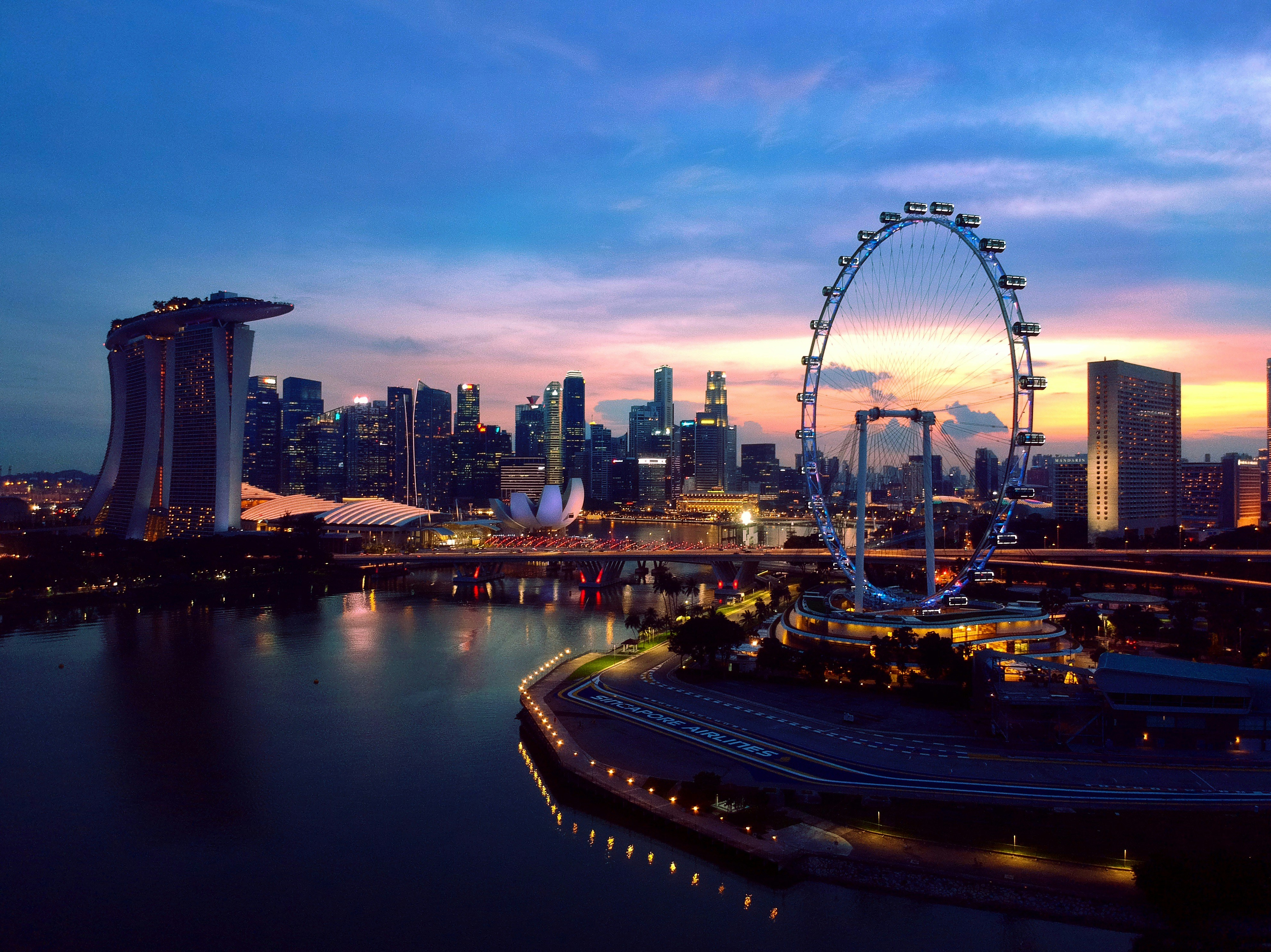 ferris wheel near body of water during night time