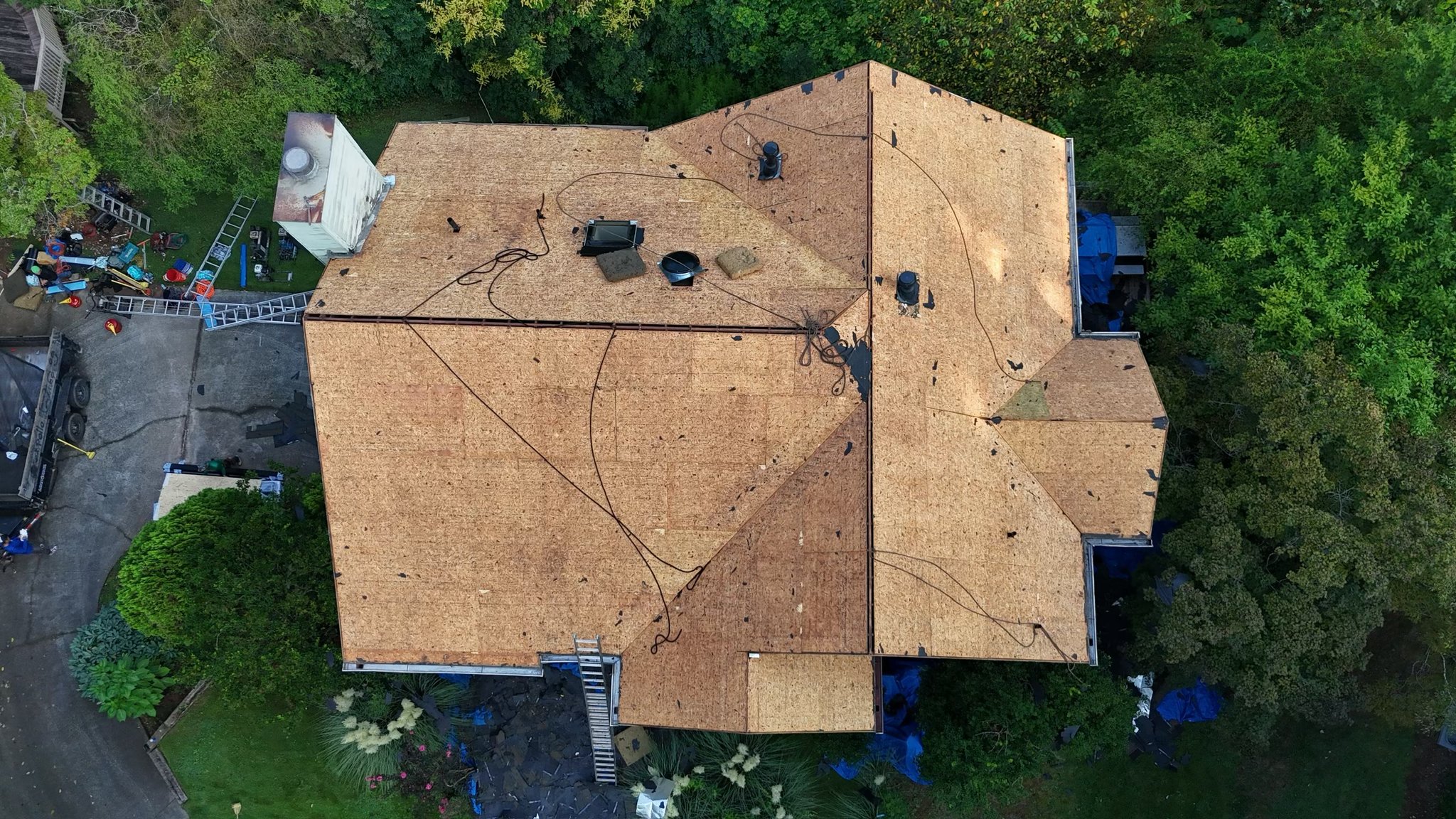 Bare roof decking seen from above after the old shingles came off, Duluth, GA