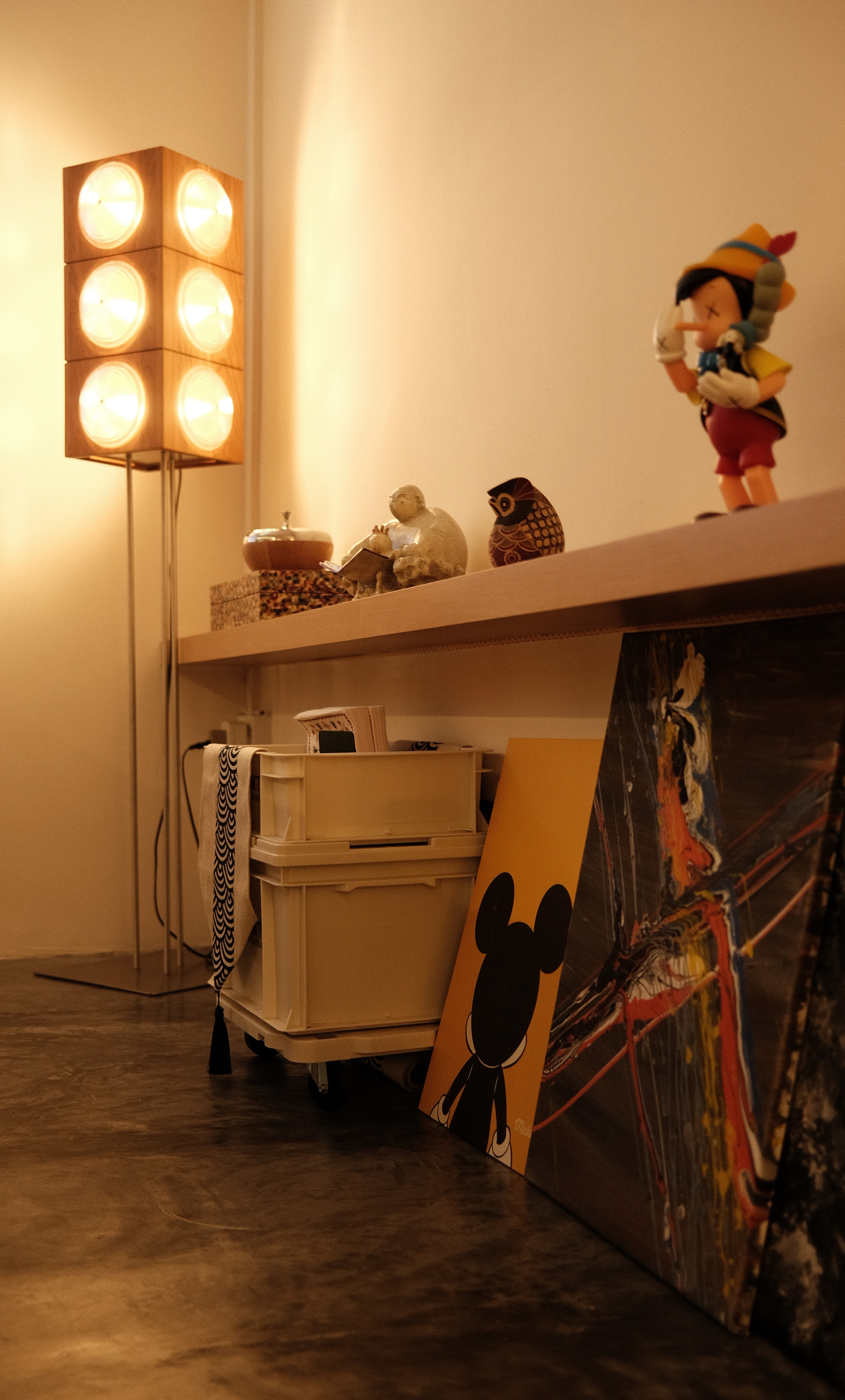 Open shelving with collectible figurines and eclectic wall art, personalized Singapore apartment interior
