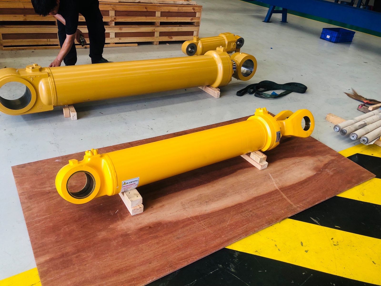 Wind turbine overlooking bright green farmland and scattered buildings