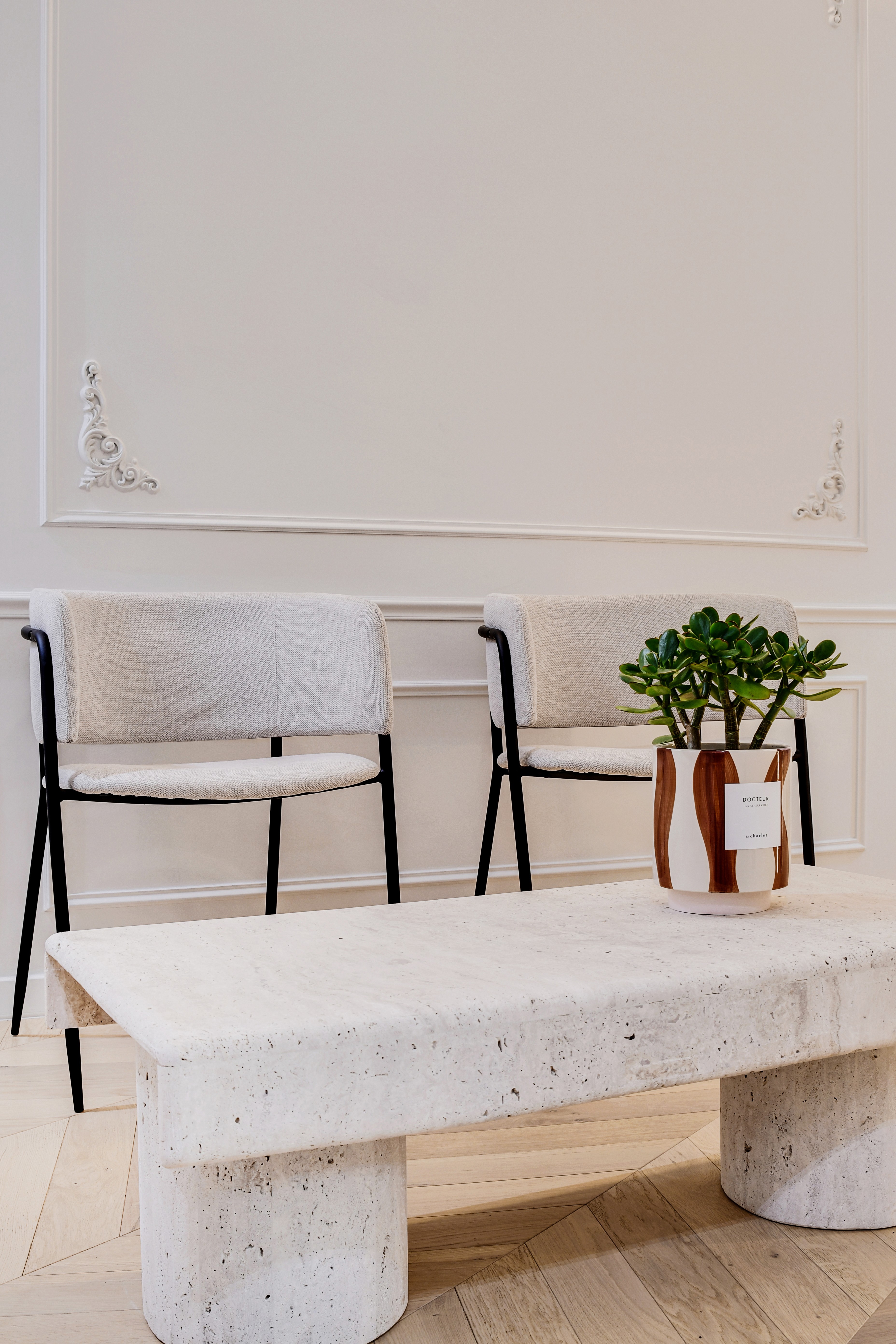 Close-up of a woman with under-eye gel patches, natural makeup, and smooth skin, against a neutral beige background