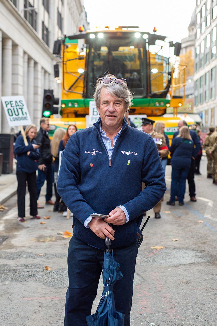 Stephen Francis, wearing a dark blue fleece top with a pea emoji pin badge, standing in front of a viner at the Lady Mayor's Show