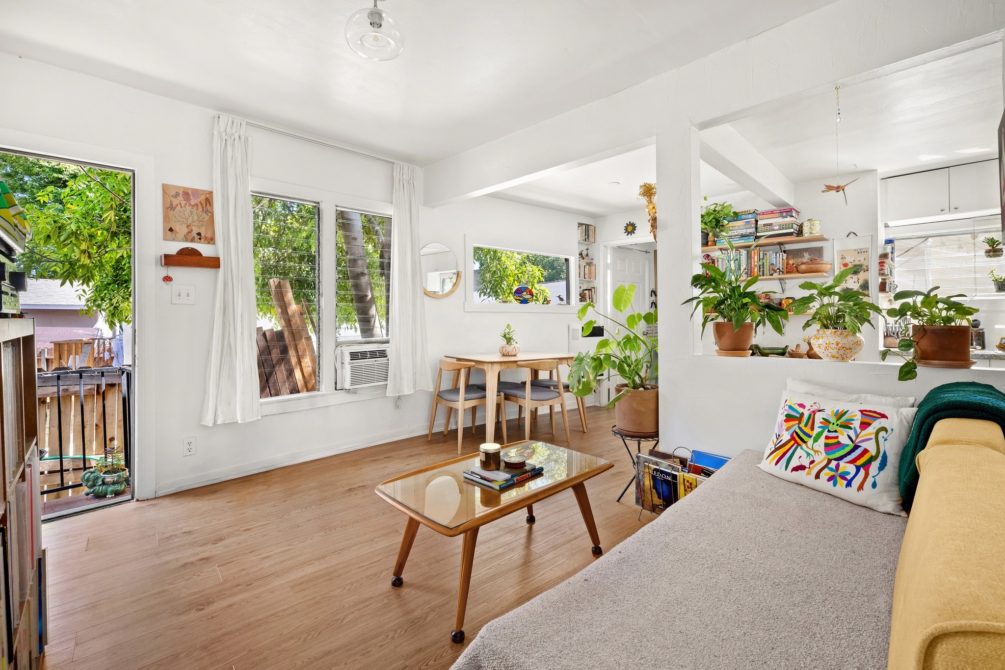 Bright and airy living space at 3456 Plata, with large windows, modern decor, and cozy seating arrangement. 
