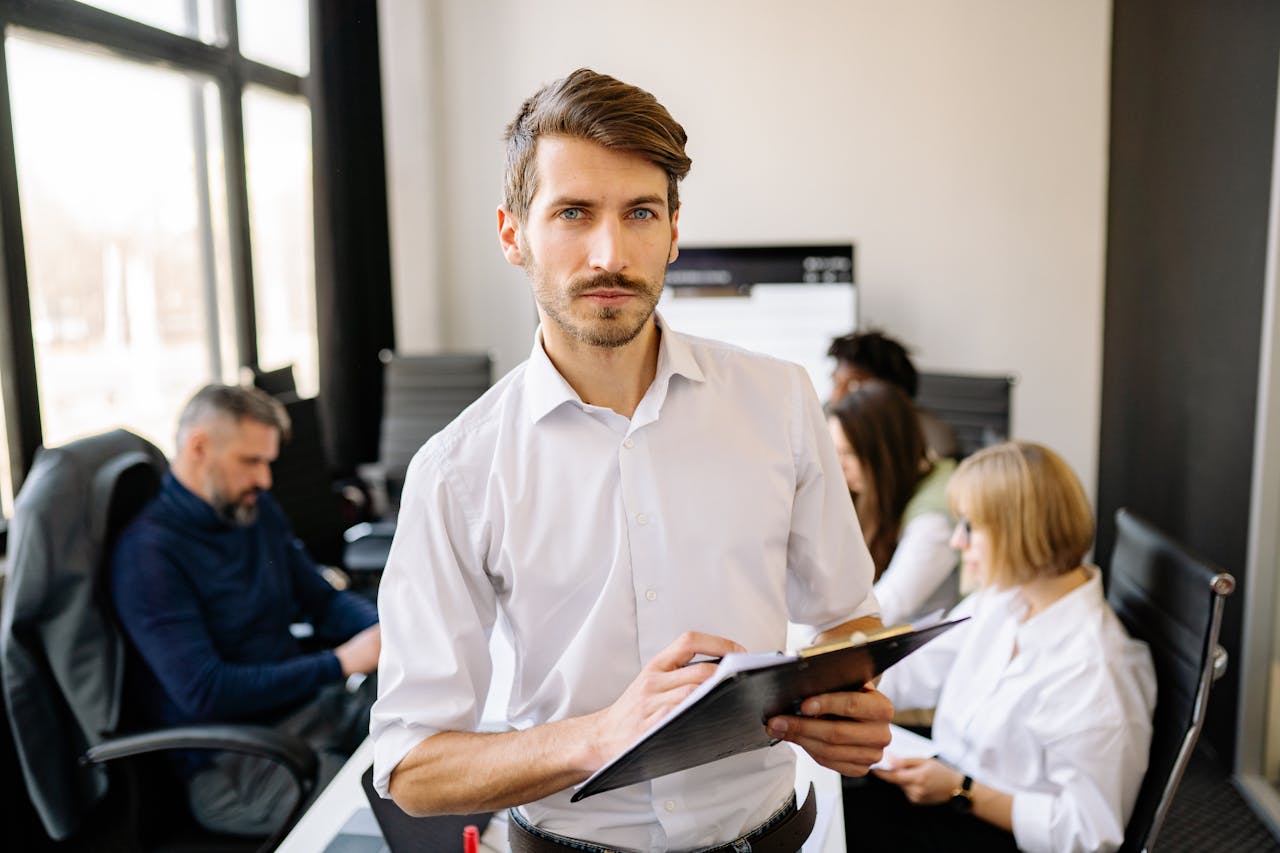 a person in a meeting room with papers in hand