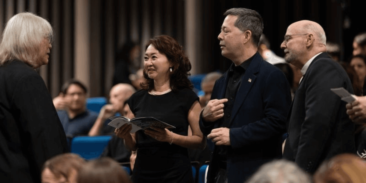 Somtow Sucharitkul speaking with U.S. Ambassador Sean O’Neil, his wife, and Archbishop Wells at a concert.