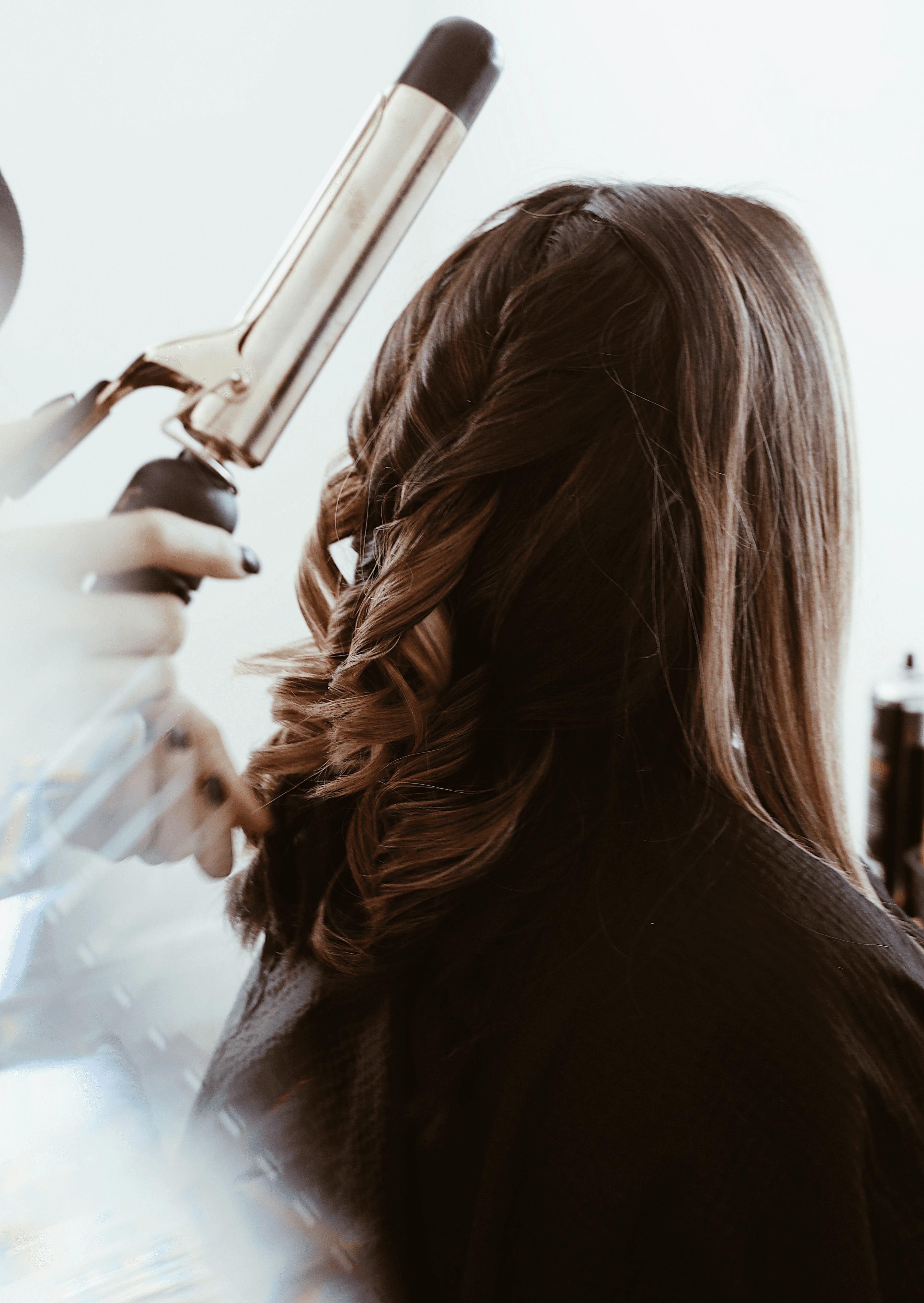 person holding gray hair curler