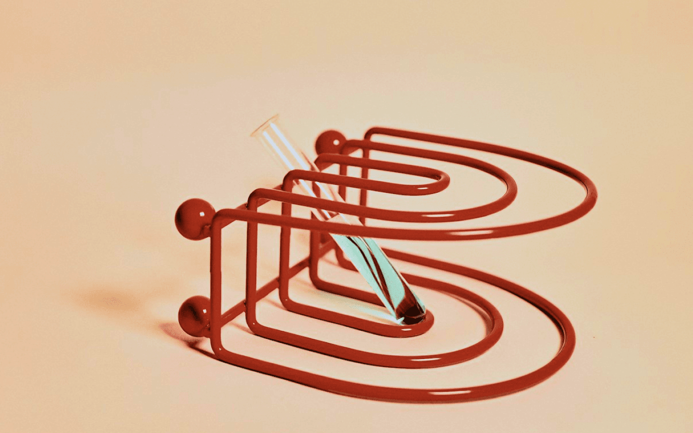 A three-dimensional maze is shaped like a letter "B," with a small figure navigating its pathways.