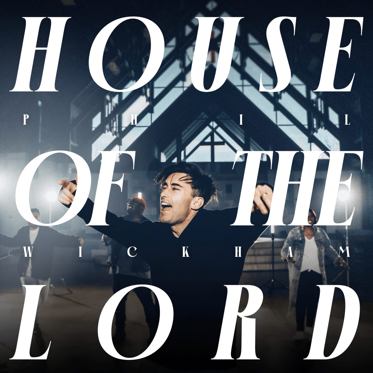 Album artwork for "House Of The Lord" by Phil Wickham shows a man singing energetically in a modern building; bold text displays song and artist name.