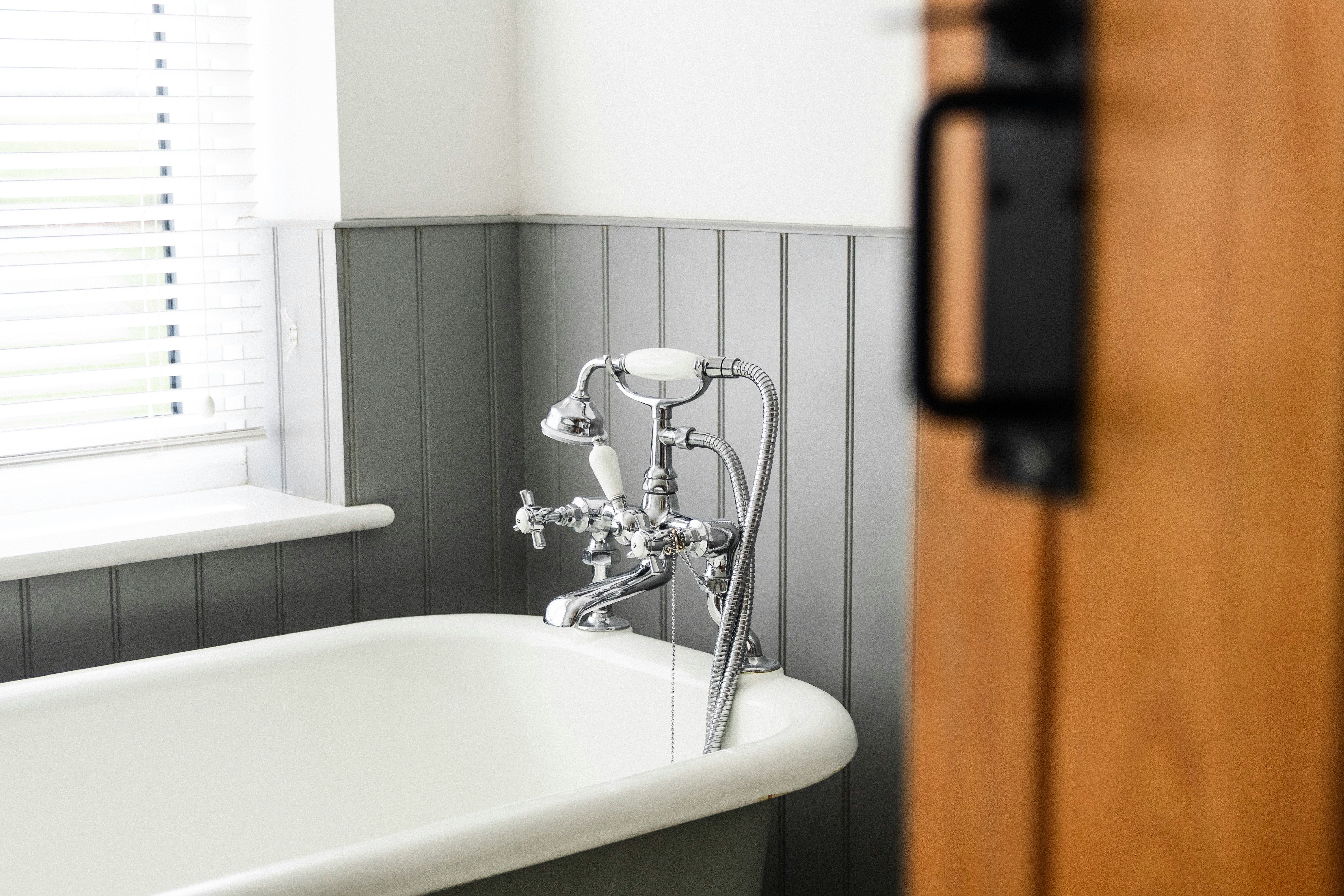 Bathroom with a clawfoot bathtub and rustic accents.