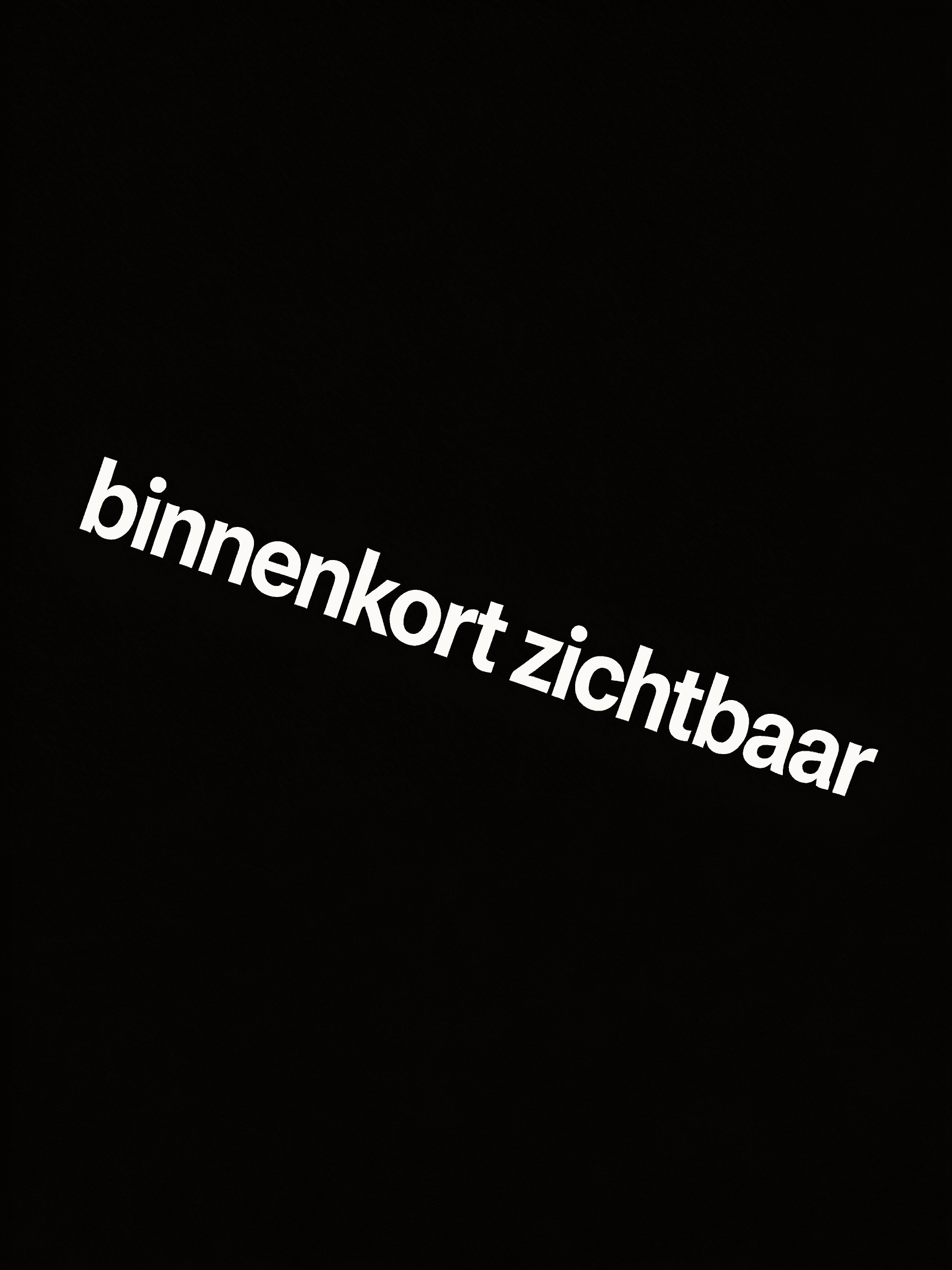 man sitting facing silver MacBook inside room