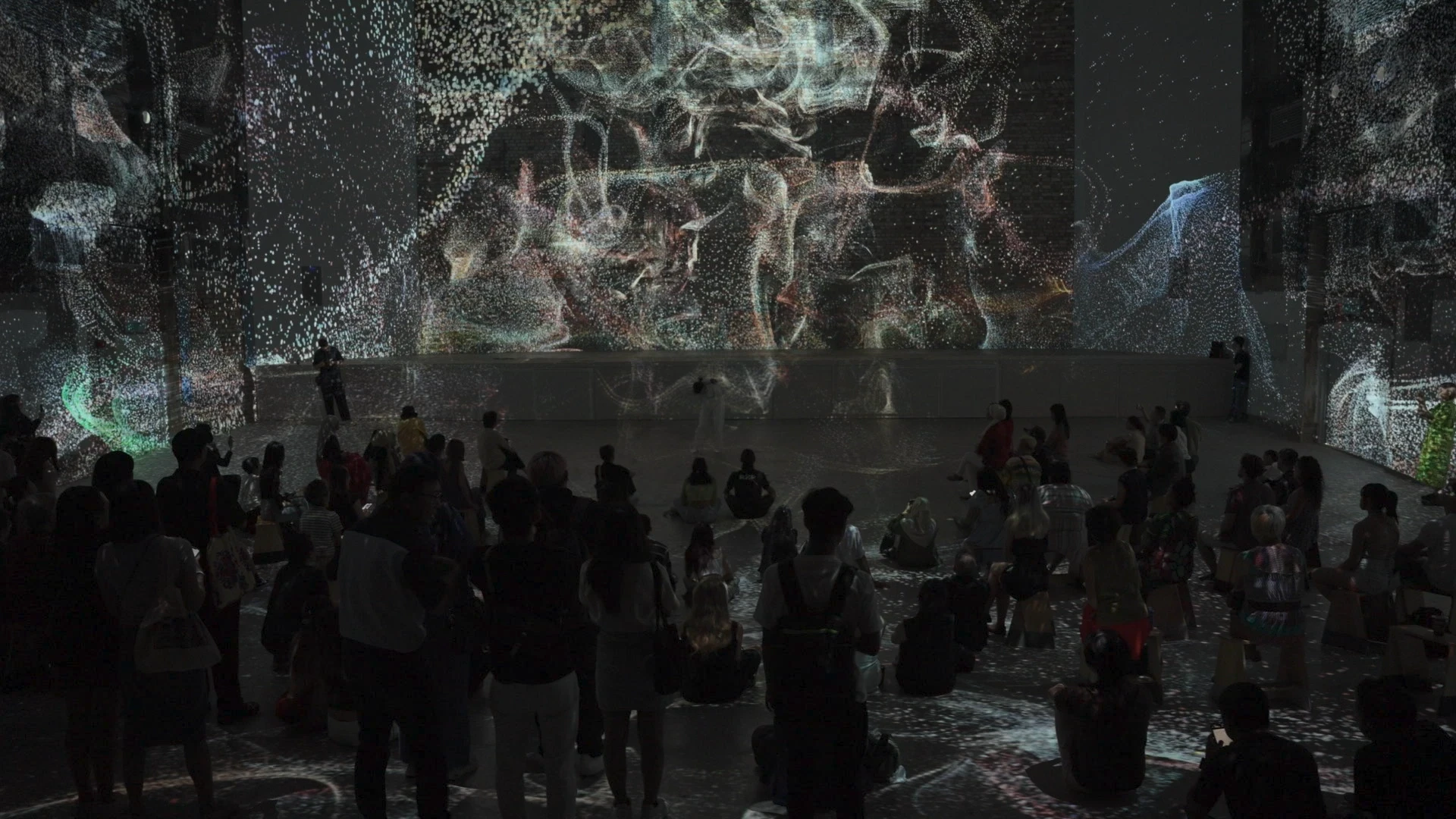 People watching projection mapping art installation