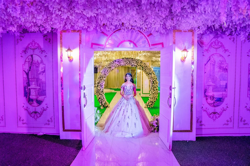 Debutante at the violet-lit doorway of Celestia Hall, Stalla Suites Events Place