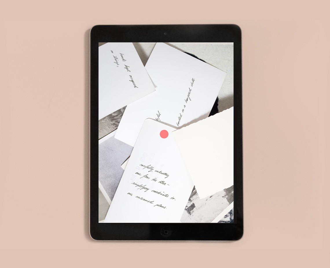 A black tablet displays a collection of white cards with handwritten text. A red dot is visible on one of the cards. The background is a light peach color.