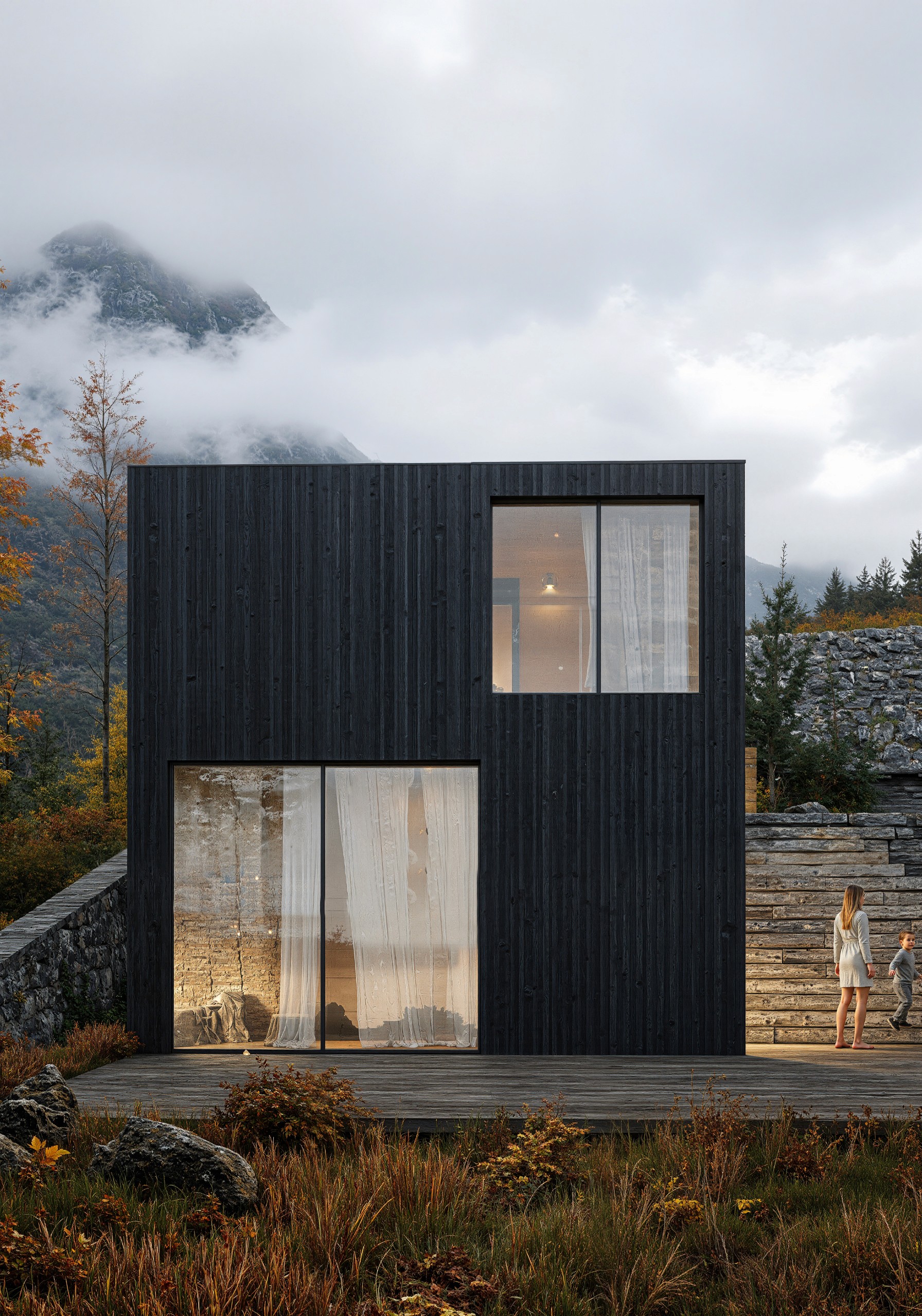 A smiling woman with her arms crossed, standing against a dark green background. She has long, dark hair.