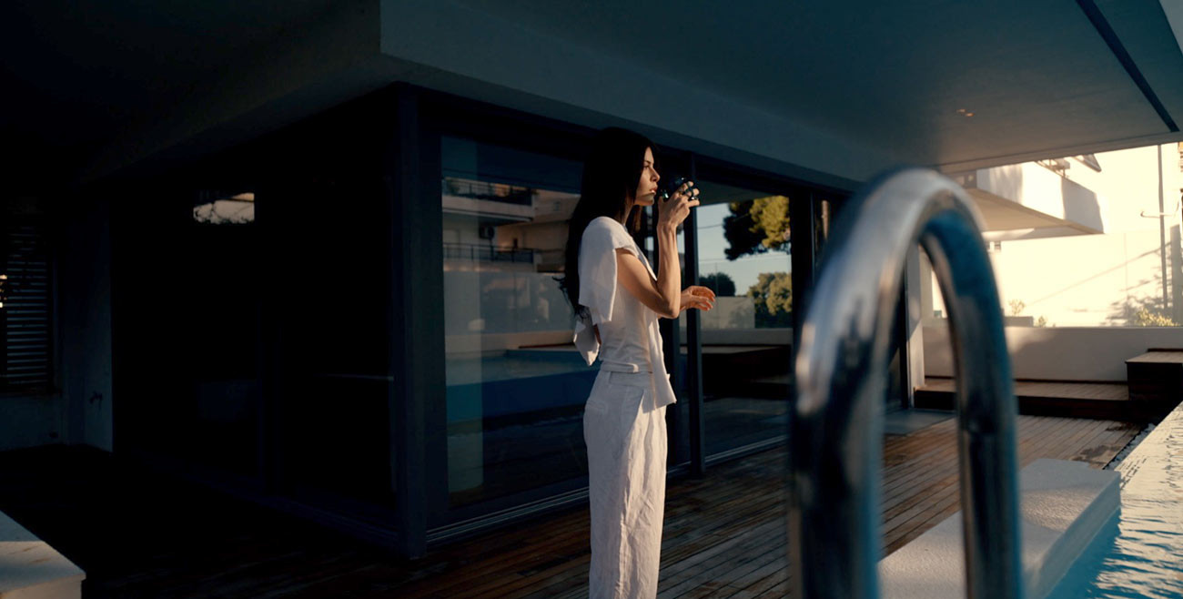 Woman beside a lit pool at night at a MIA Developments residence, photographed by TERAMOK