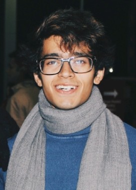 man standing beside wall