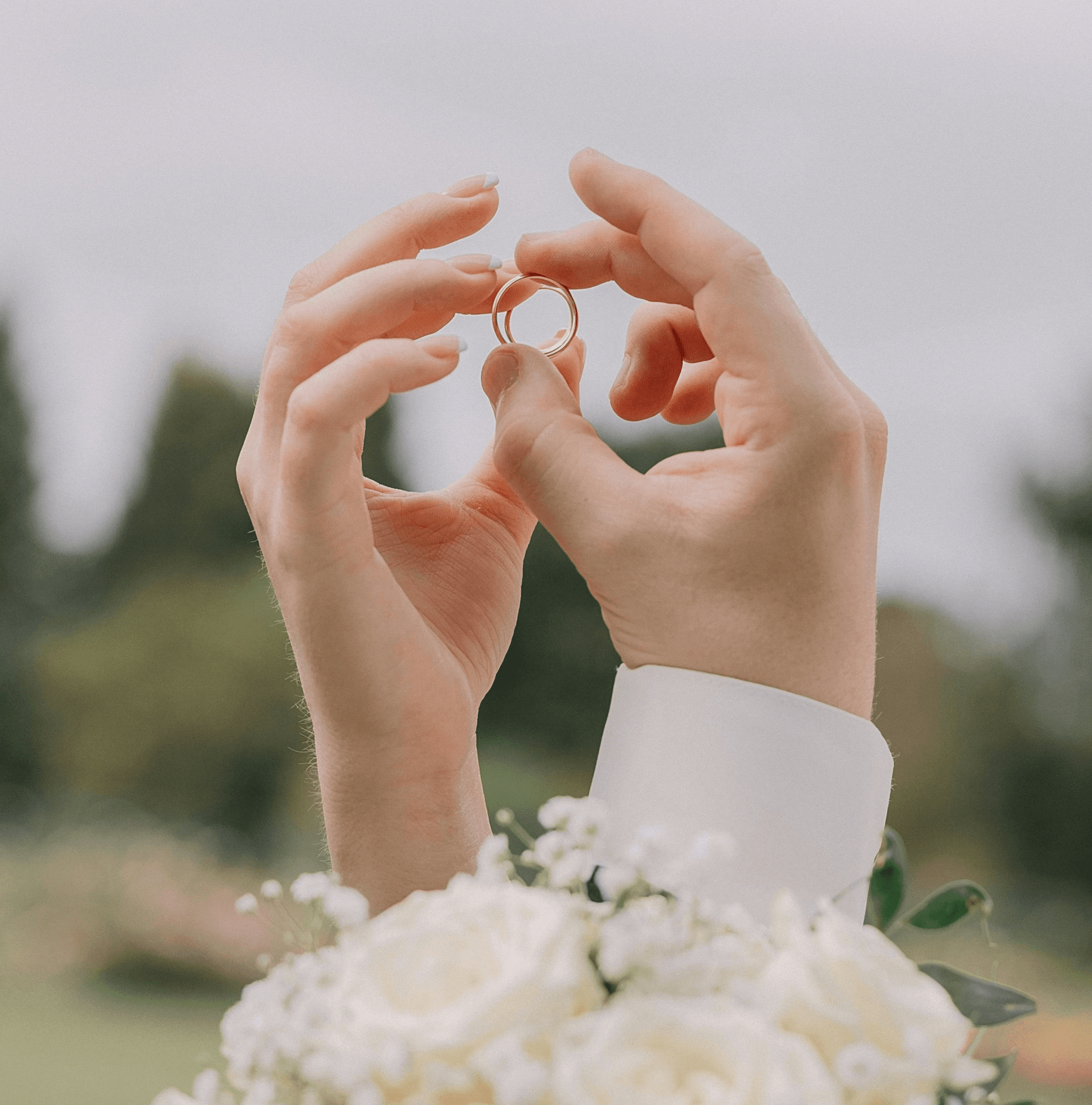 Hands holding wedding rings