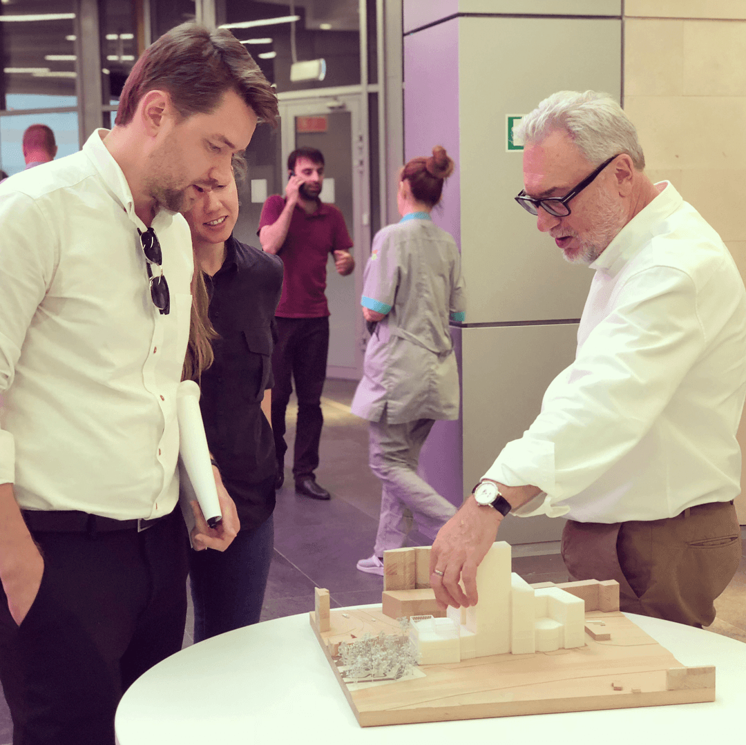 Two men are looking at 3d printed miniature of a commercial building