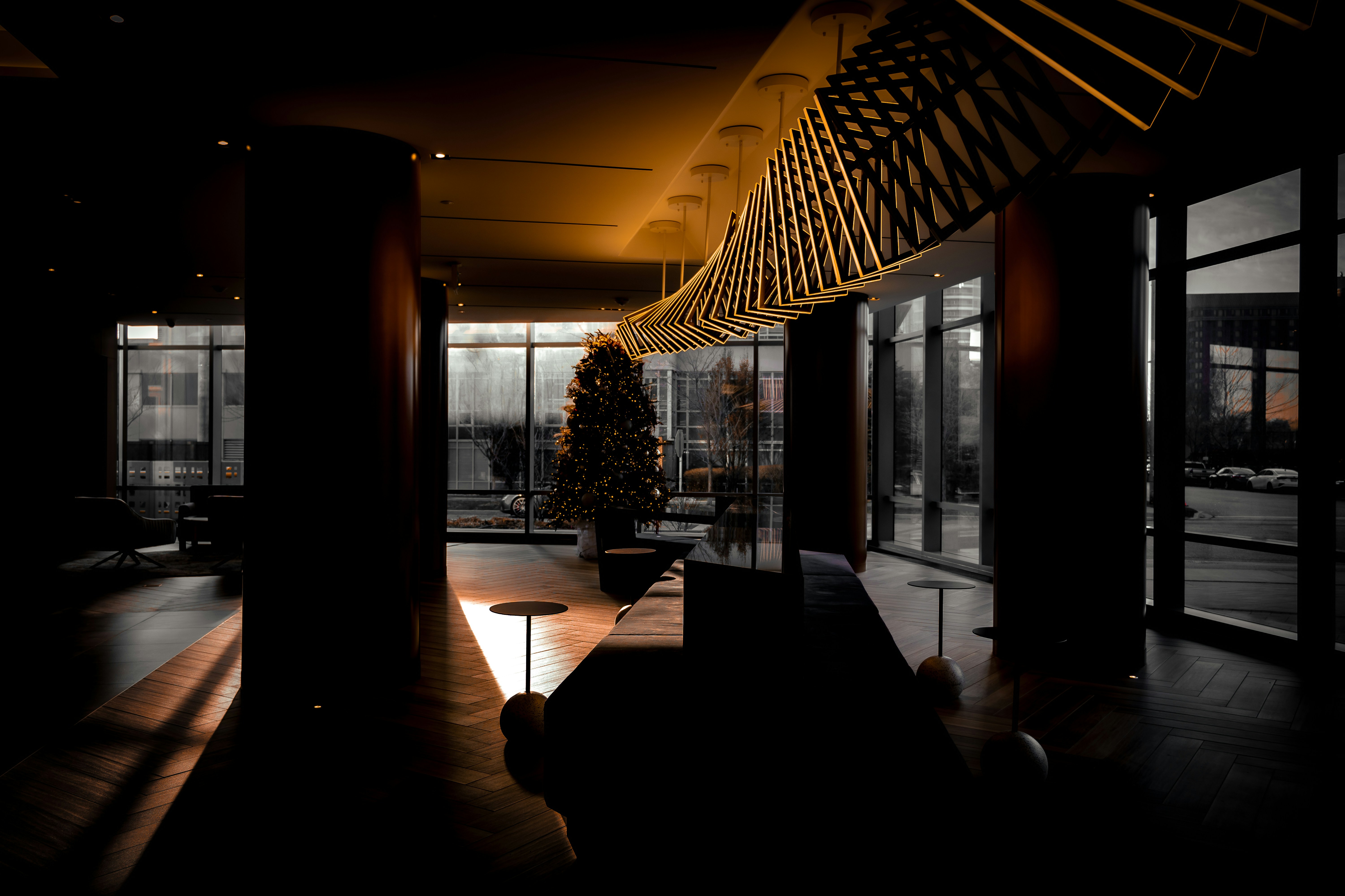 a living room with a christmas tree in the middle of it