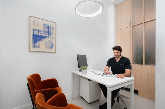 Dr. Igor Milanovic at dental consultation desk making treatment notes at Sovrle Dental Clinic in North York, Ontario: the best dentist in North York, Ontario