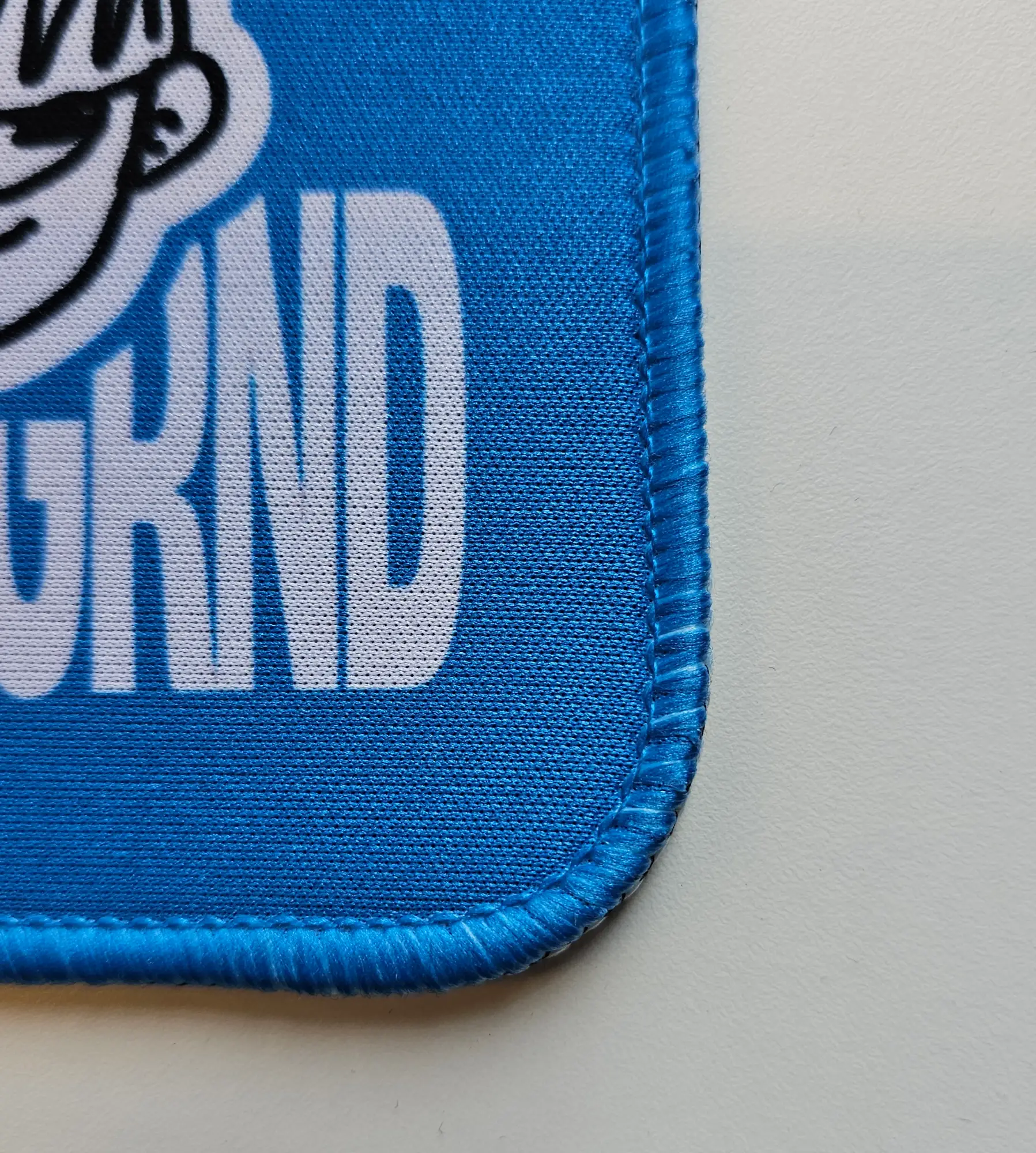 Close-up of a deskmat edge showing its thickness