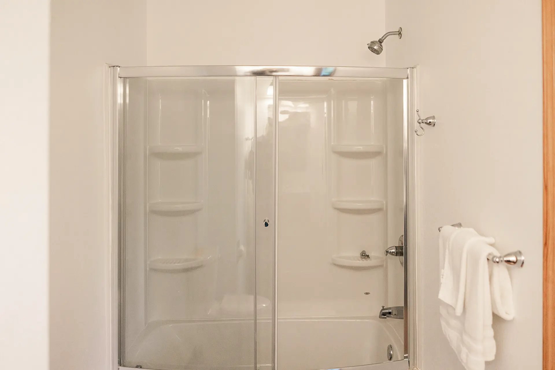 Bathroom with glass-door tub and shower combo.