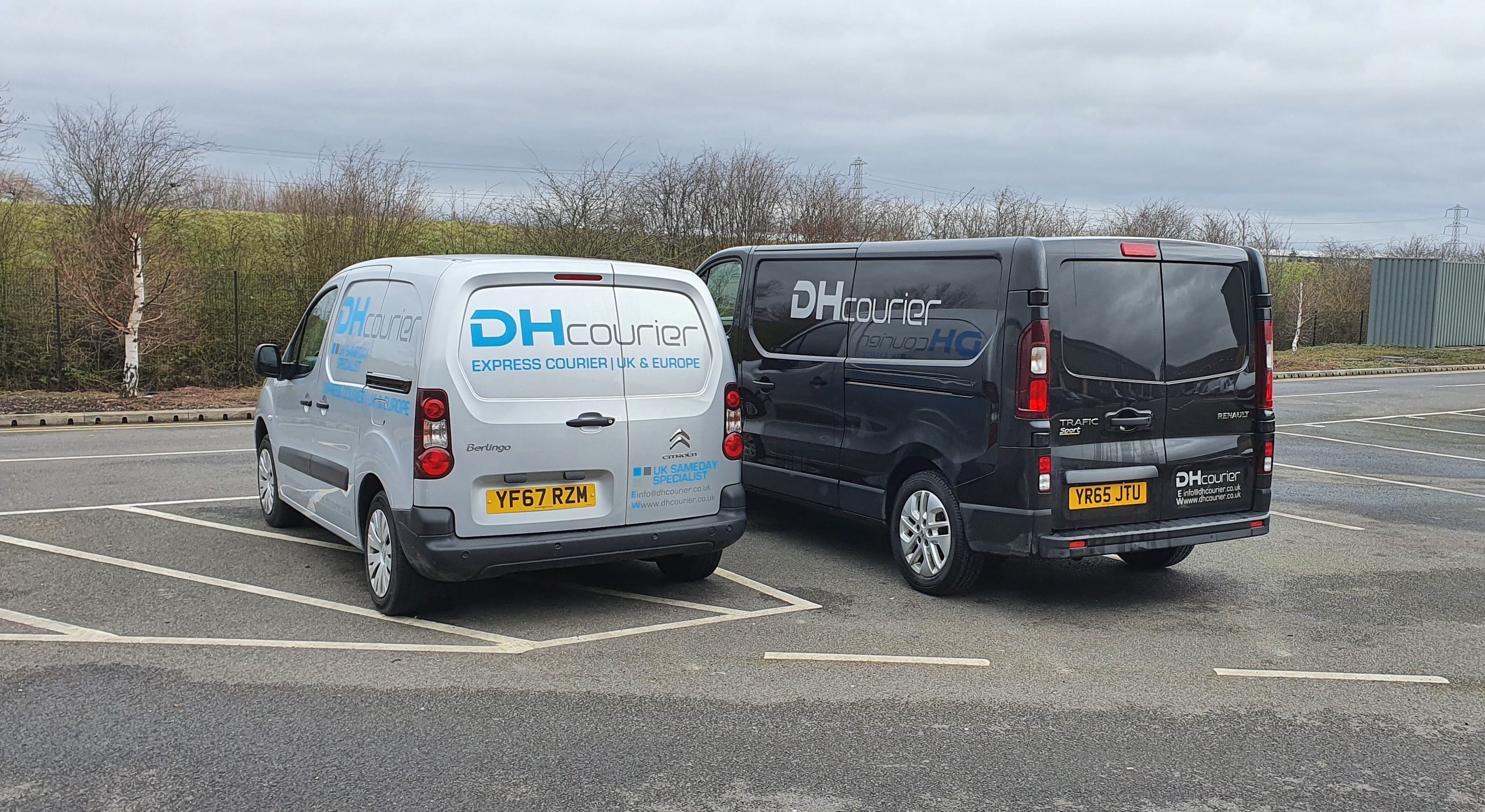 Two Vans Parked Next to Each Other