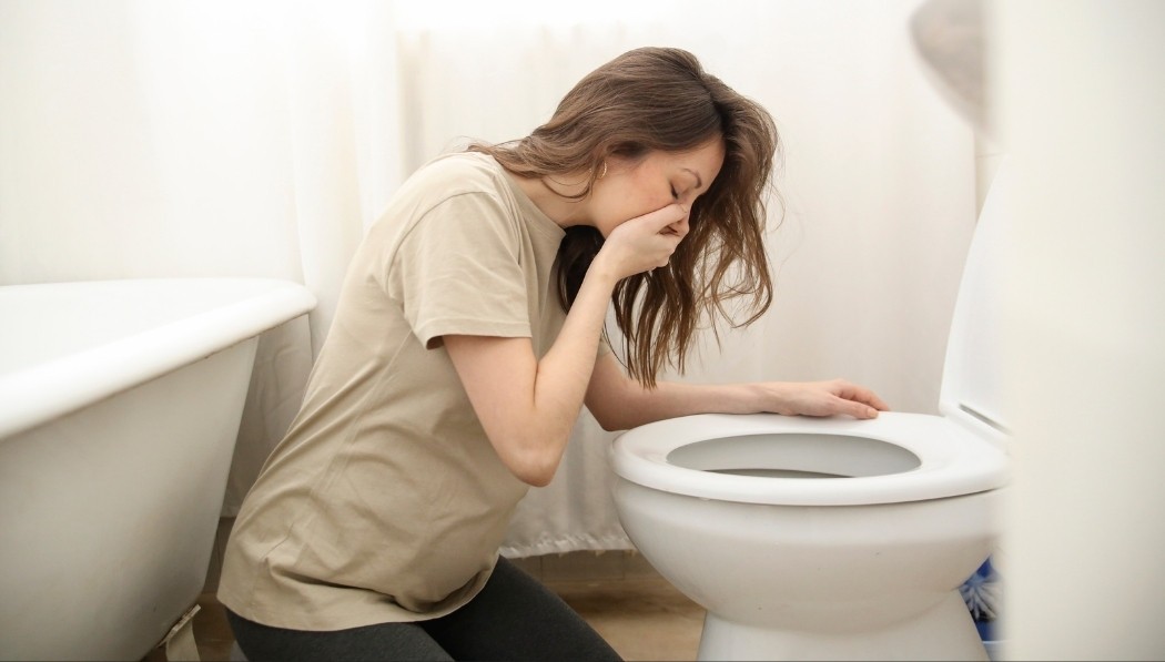 Woman experiencing morning sickness, illustrating the need recognition stage in the consumer decision-making process