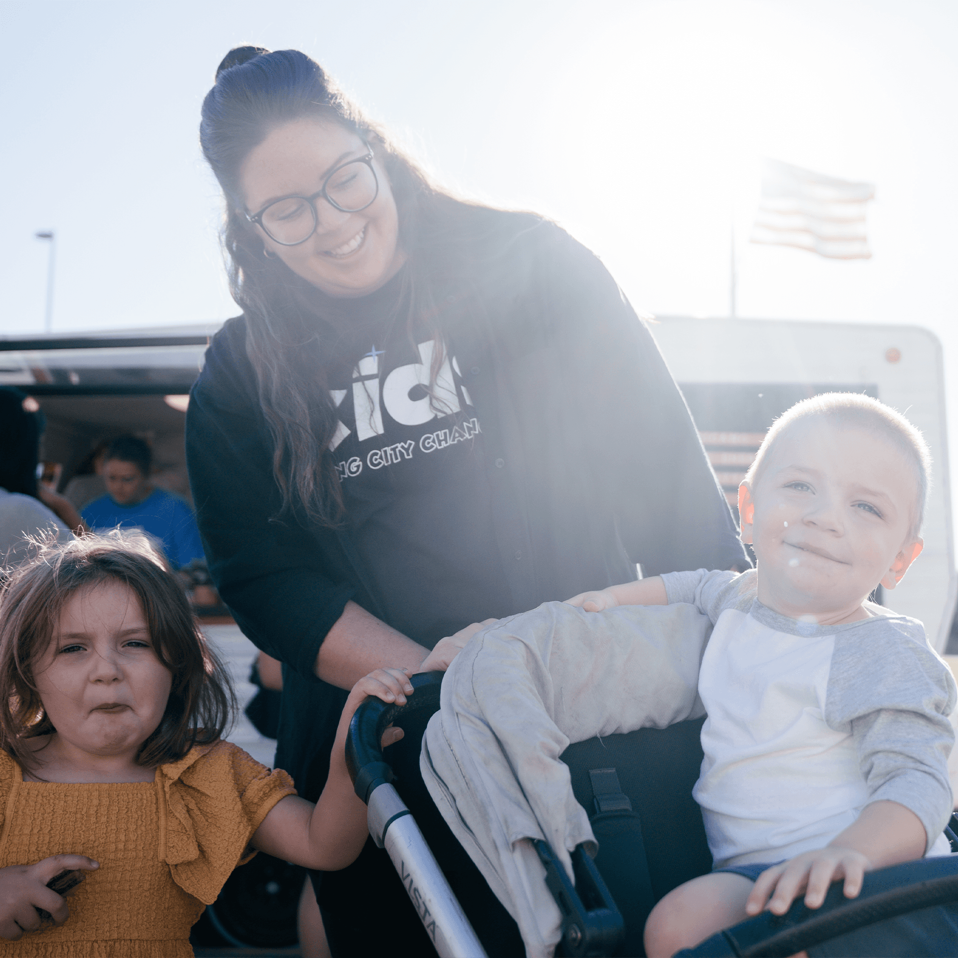 A mom and her kids smiling together.