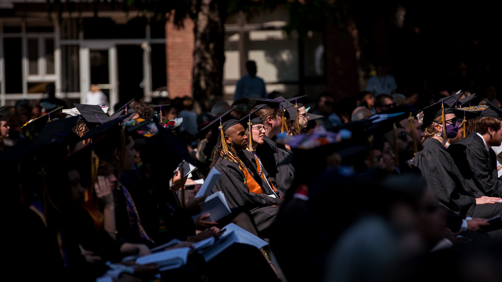 A group of graduates in caps and gowns at a university degree ceremony