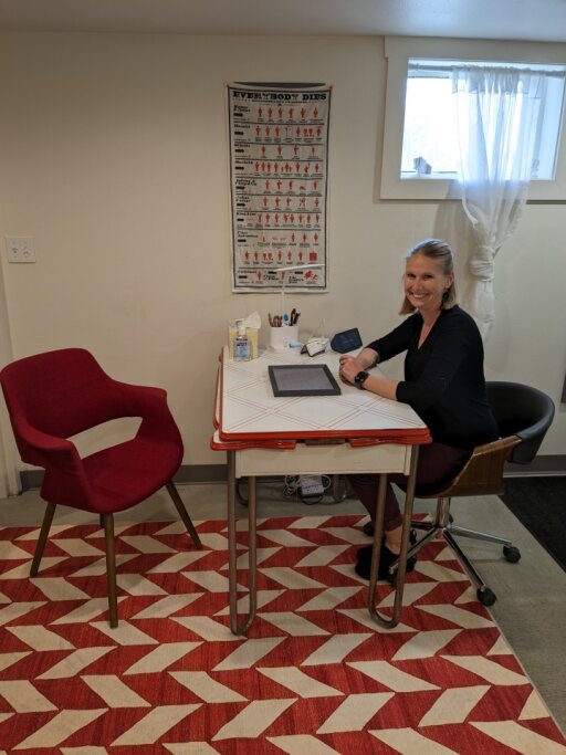 a woman is putting a pair of earplugs on her ear